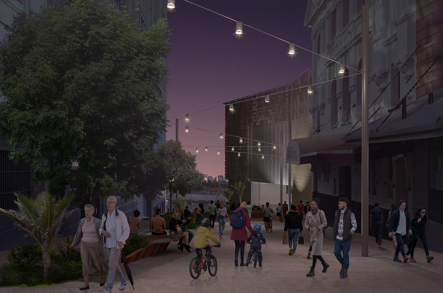 People strolling through a pedestrian area between buildings at dusk, with string lights overhead